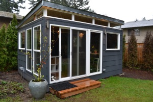 The Combs family opted for two Modern-Sheds, including this 12' by 16' Modern-Shed home office in #deepspace blue paint by Benjamin Moore.