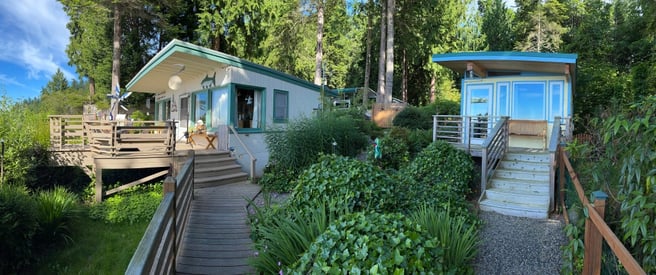A Modern-Shed next to a waterfront cabin.