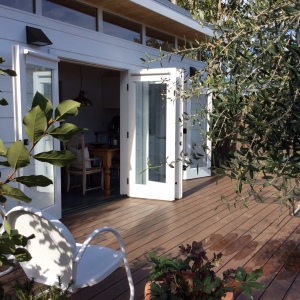 French doors open up the indoor kitchen space to the outdoor deck.