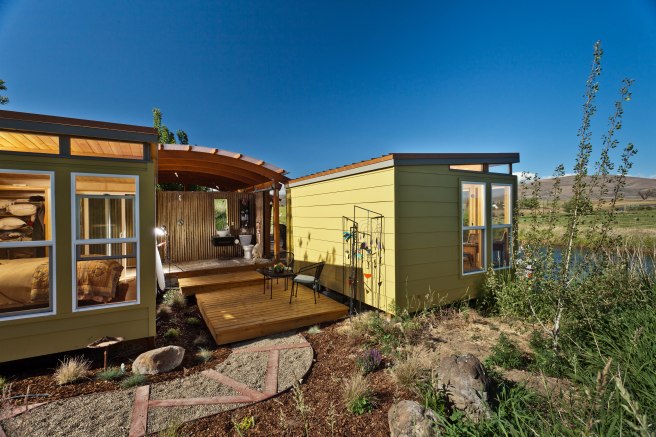 Two sheds linked together by a deck.