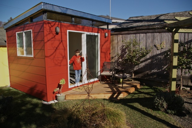 Dylan, 9, hangs out in his mother's Modern-Shed, which has come to have many uses.